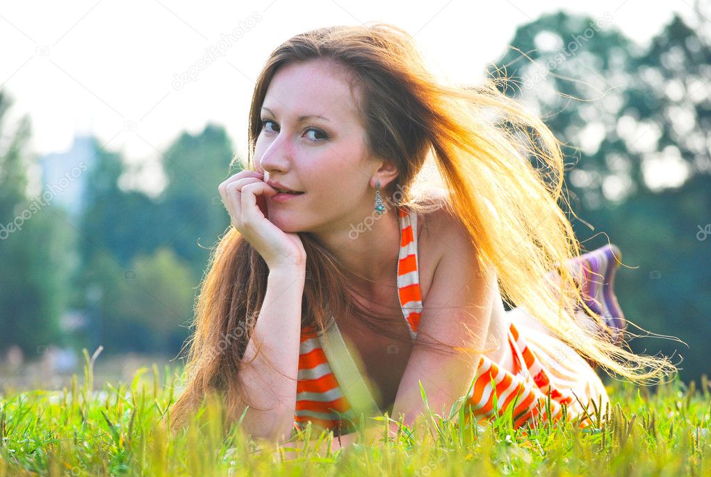 Beautiful woman laying on grass