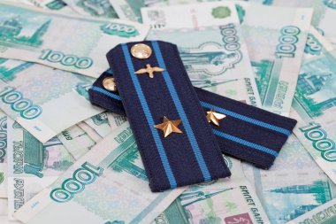 Shoulder strap of russian army on money background clipart