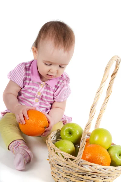 Baby girl in pink and fruits — Stock Photo, Image