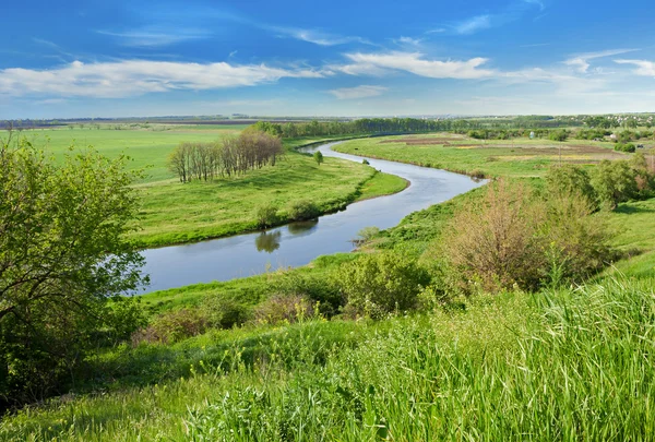 stock image Green field, river and blue sky