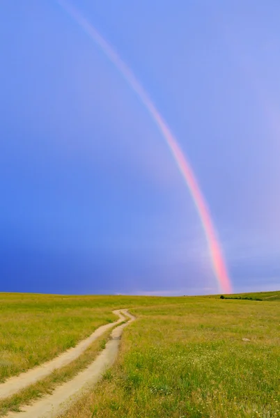 Rainbow over the field — Stock Photo, Image
