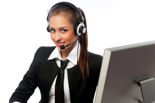 Girl with a headset works at the computer — Stock Photo, Image