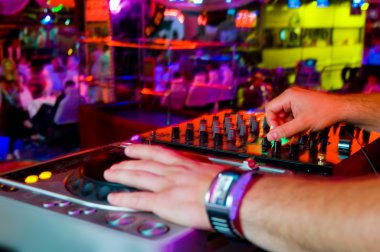 Dj mixes the track in the nightclub at a party clipart