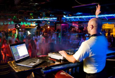 Dj mixes the track in the nightclub at a party clipart