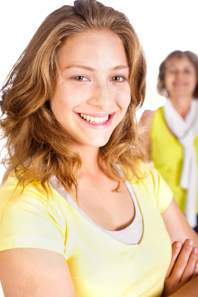 Gorgeous woman in focus with her mom in the background — Stock Photo, Image