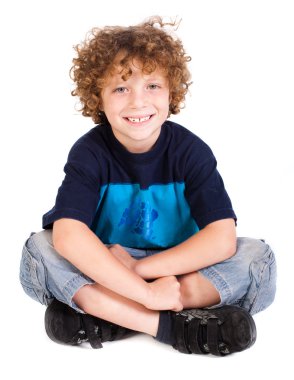 Cheerful kid relaxing on floor clipart