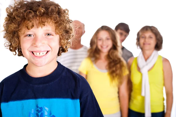Adorable young kid in focus with family in the background — Stock Photo, Image
