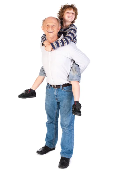 Dědeček dávat vnuk prasátko zpět — Stock fotografie