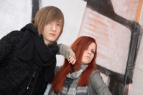 stock image Girl and young man against wall from graffiti