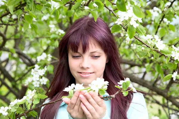 The girl-teenager hold in hand branch with flower — Stock Photo, Image