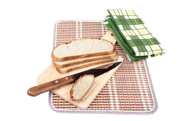 Slices of bread with knife chopping board and towel — Stock Photo, Image