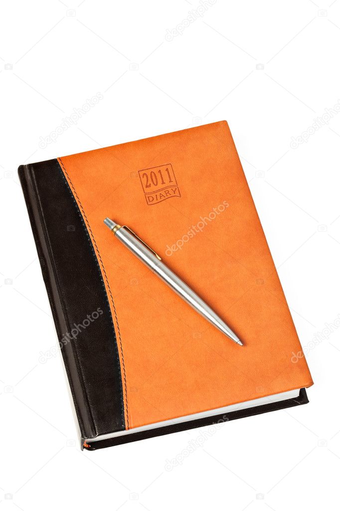 Diary and pen on table isolated