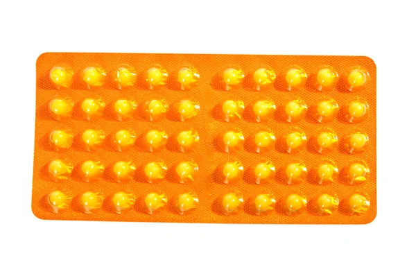 Paket mit gelben Tabletten — Stockfoto