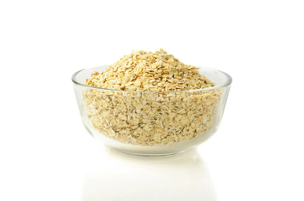Dry oat grains in glass bowl — Stock Photo, Image