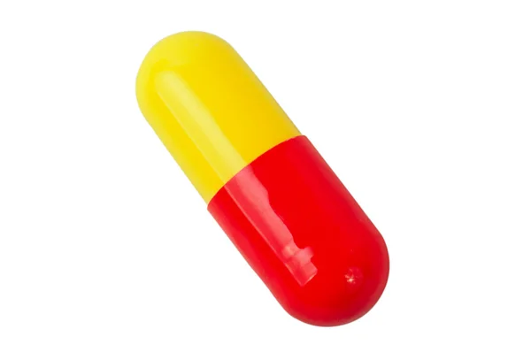 Одна красно-желтая медицинская таблетка — стоковое фото