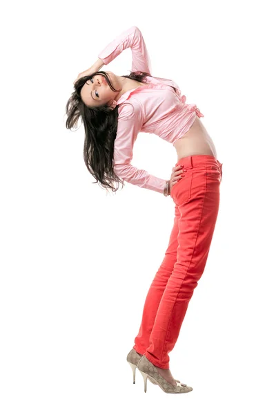Pretty sexy young brunette in red jeans — Stock Photo, Image