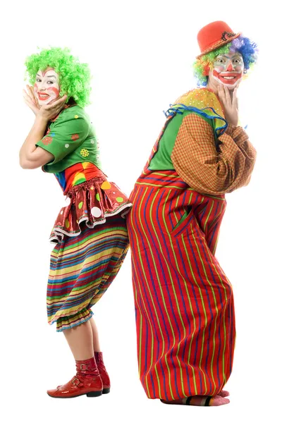 Два улыбающихся клоуна спины к спине — стоковое фото
