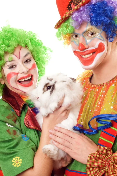 Two cheerful clown with a white rabbit — Stock Photo, Image