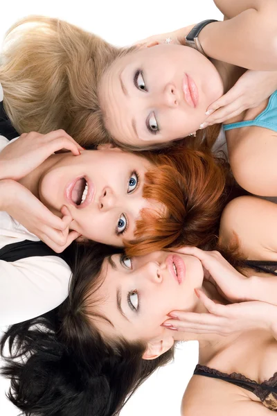 Tre förvånad kvinnor röra deras kinder — Stockfoto