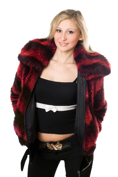 Lachende jonge blonde vrouw in een bont jas — Stockfoto
