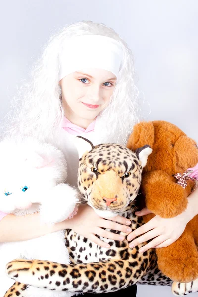 Girl in a wig with a toy — Stock Photo, Image