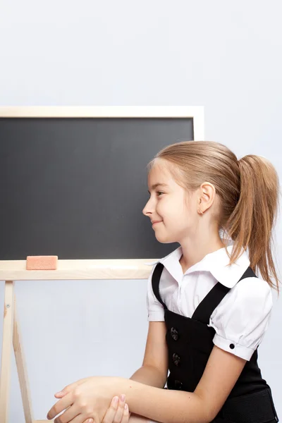Schoolgirl about a schoolboard — Stock Photo, Image