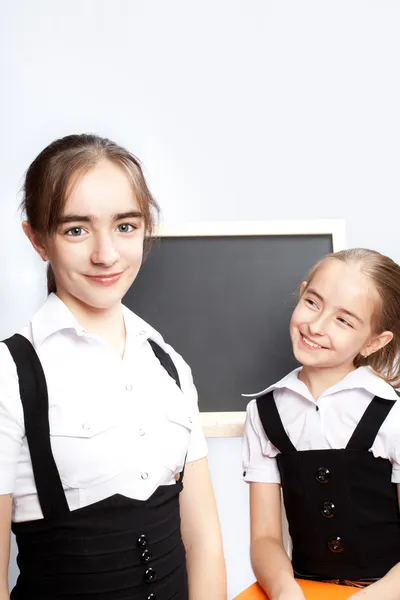 Schoolgirls and schoolboard — Stock Photo, Image