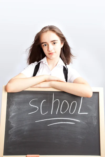Schoolgirl about a schoolboard — Stock Photo, Image