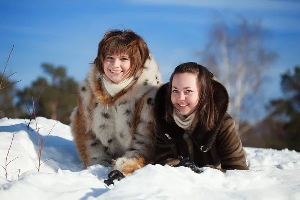 Women lying on the snow in winter — Stock Photo, Image