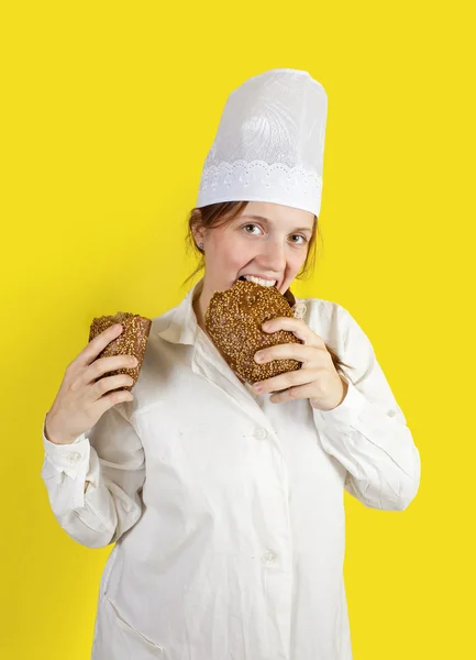 Woman is eating bread — Stock Photo, Image