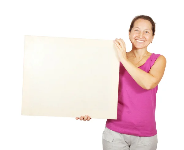 Woman in sport outfit holds blank canvas — Stock Photo, Image