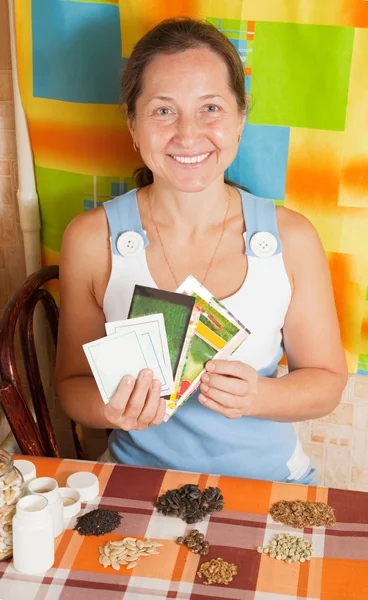 Woman with various seeds — Stock Photo, Image