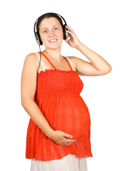 Gravid kvinna lyssna på musik — Stockfoto