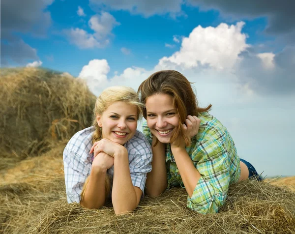 Girls on hay in summer — Stock Photo, Image