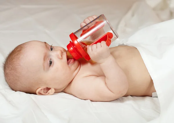Little girl with baby bottle — Stock Photo, Image