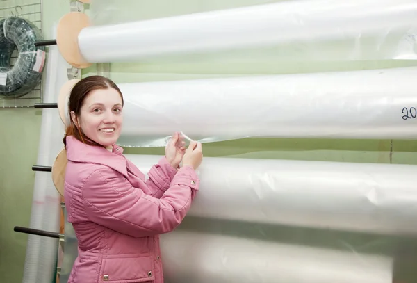 Woman chooses polythene for hothouse — Stock Photo, Image