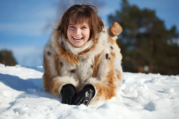 Jonge vrouw liggen op sneeuw — Stockfoto