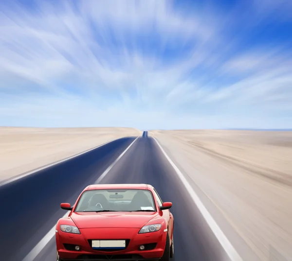 Κόκκινο αυτοκίνητο στον έρημο δρόμο — Φωτογραφία Αρχείου