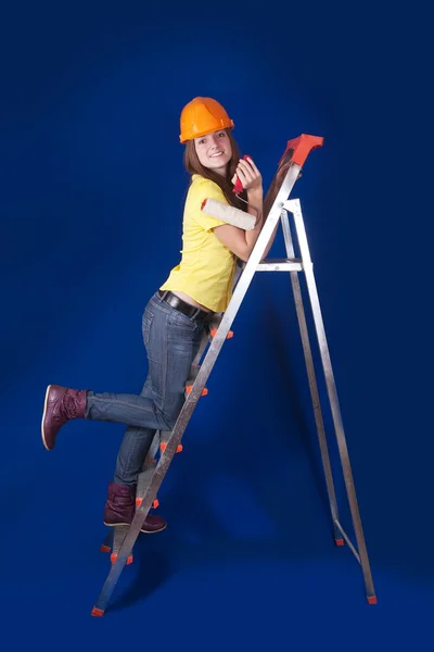 Girl with paint rollers on stepladder — Stock Photo, Image