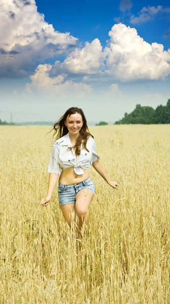 Бегущая девушка на пшеничном поле — стоковое фото