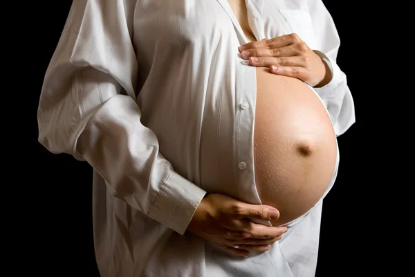 Tummy of 9 months pregnant woman Stock Image