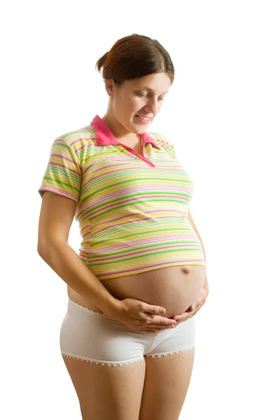 Gravid kvinna ser magen — Stockfoto