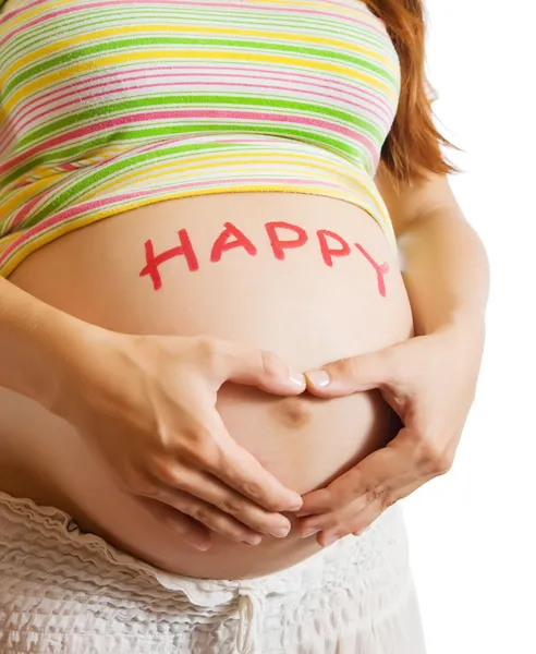 Zwangere buik met hart uit handen — Stockfoto
