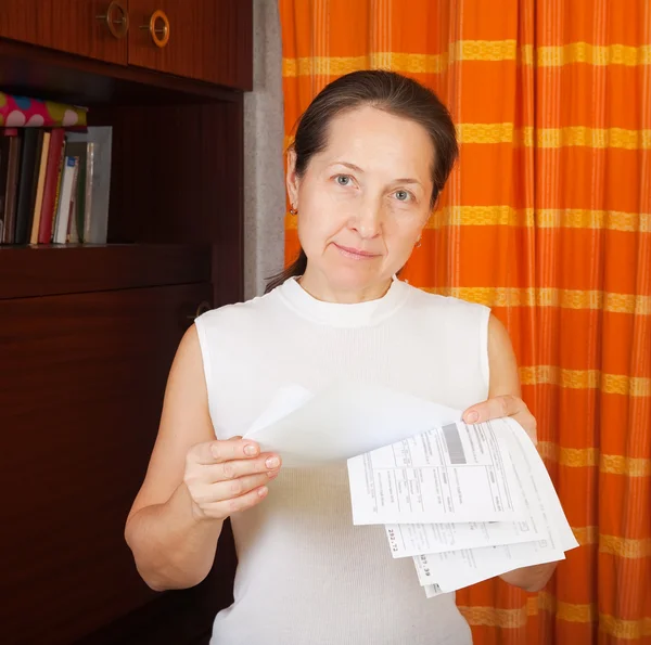 Mature woman with utility bills — Stock Photo, Image