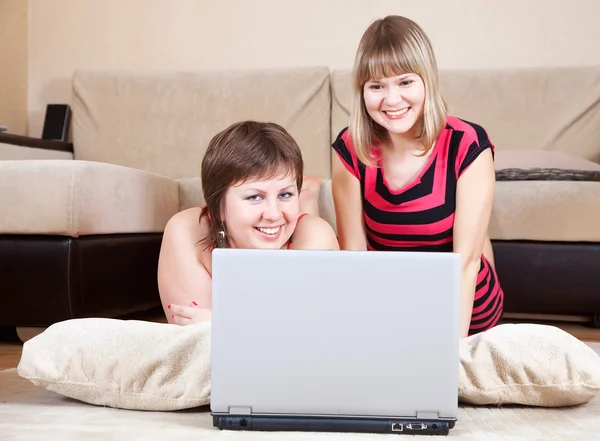 Glada tjejer använder laptop i hem — Stockfoto