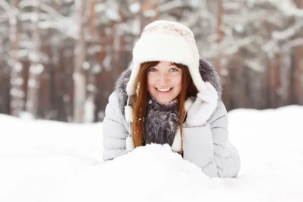 Girl lying down on snow Royalty Free Stock Images
