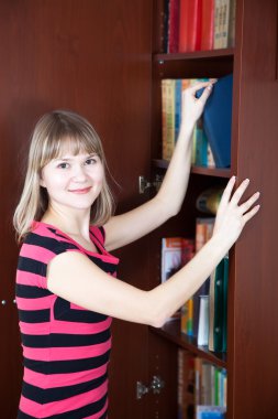 Girl selecting book clipart