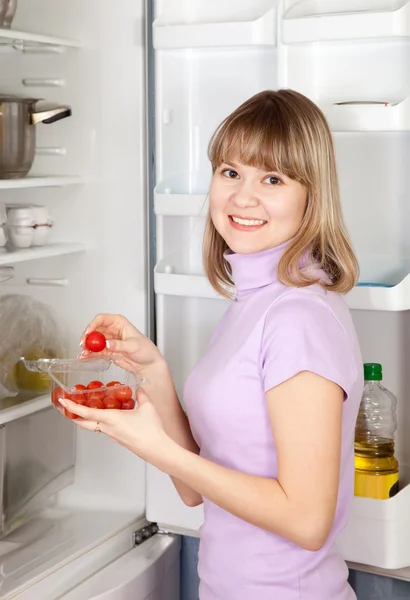Nő vesz cseresznye paradicsom hűtőszekrény — Stock Fotó