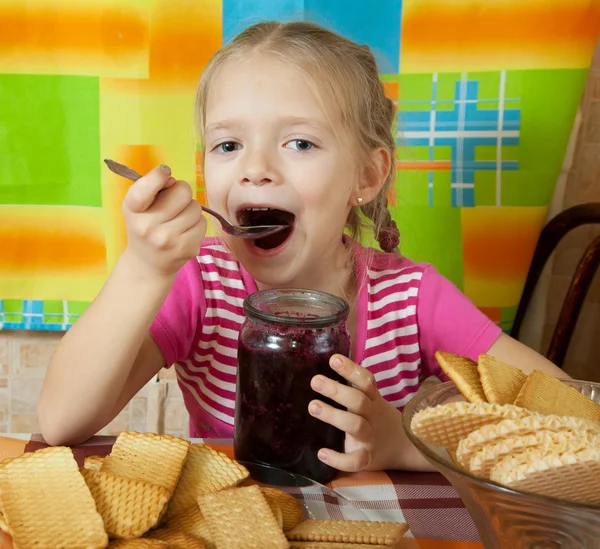 Little girl eating jam — Stock Photo, Image