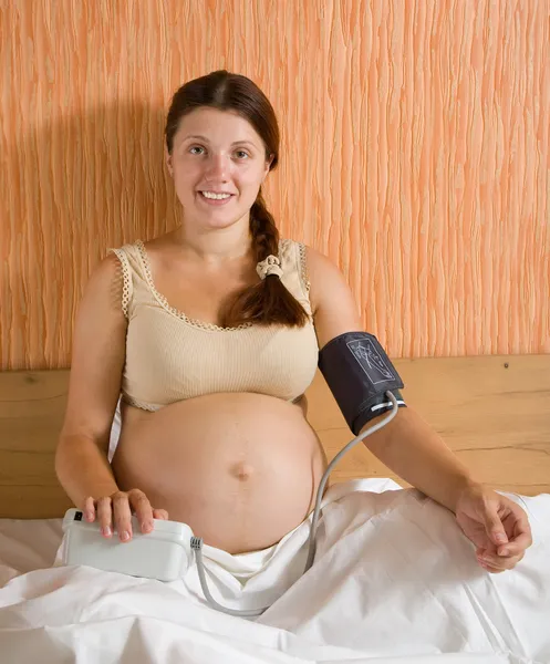 Mujer embarazada que mide la presión — Foto de Stock